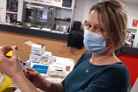 A volunteer prepares a vaccine at a Doncaster vaccination centre