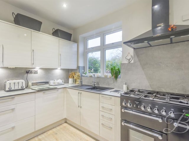 The kitchen also benefits from a Rangemaster double oven, tiled splashback, five-ring cooker, under-cabinet lighting, downlights and a central heating radiator. You won't need to change a thing!