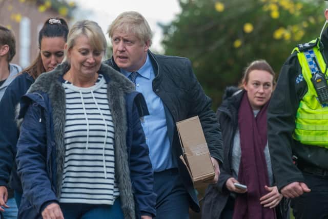 Date: 13th November 2019.
Picture James Hardisty.
The prime minister Boris Johnson, arriving at St Cuthbert's Church, Fishlake, near Doncaster, before chatting with victims and volunteers of the floods, pictured walking with Pam Webb, from Truffle Lodge, Trundle Ln, Fishlake, Doncaster.