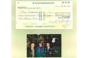 Noel Gallagher with Rick Harrison (left) and Eric Haydock of The Hollies after a shopping trip to Music Ground in December 1994 - with the cheque - signed by the star - showing how he forked out £2,250.