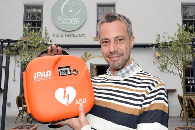 Darren Eastwood, Cadeby Pub and Restaurant general manager, pictured with the defibrillator. Picture: NDFP-04-09-21-Defibrillator 3-NMSY
