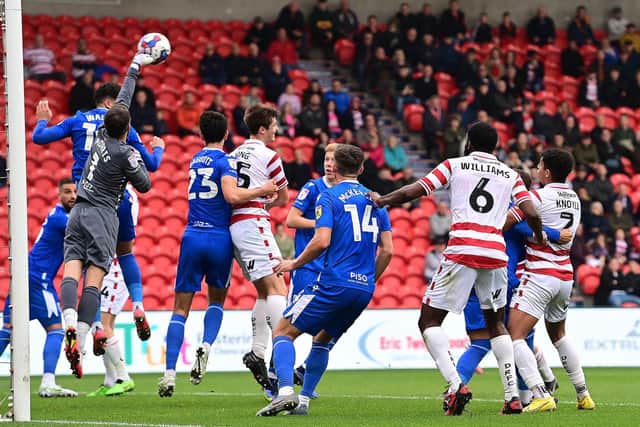 Adam Long challenges for an aerial ball against Gillingham.