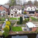 The rear tiered garden stretches down to the canal, where the property has mooring rights.