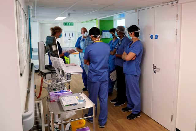 Members of medical staff wearing PPE (personal protective equipment) (Photo by STEVE PARSONS/POOL/AFP via Getty Images)