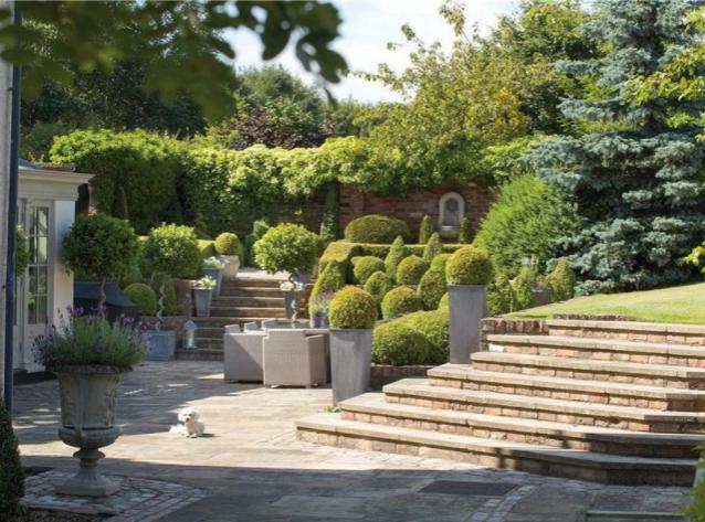 The private gardens are delightful with elevated lawns and strategically placed terracing, a further secret garden on the western side.