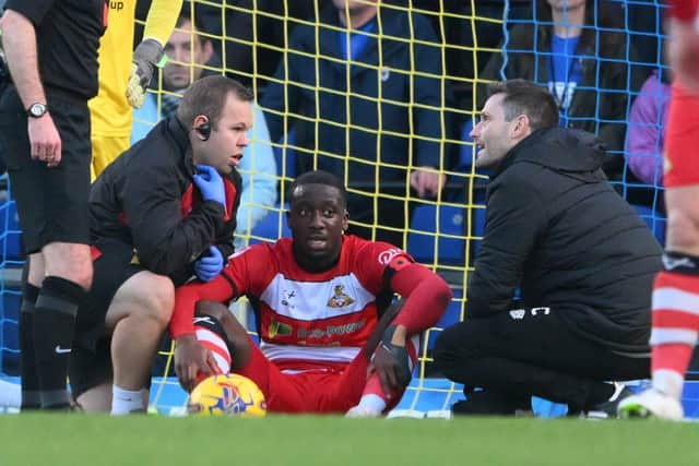 Doncaster Rovers defender Joseph Olowu suffered a concussion against AFC Wimbledon.