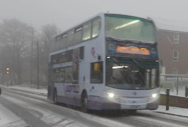 A bus driving in the snow today