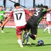Doncaster's Lee Tomlin is brought down by Northampton's Shaun McWilliams for a penalty.