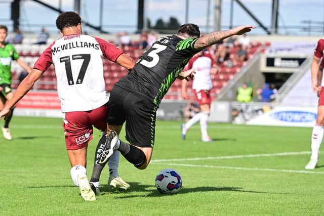 Doncaster's Lee Tomlin is brought down by Northampton's Shaun McWilliams for a penalty.