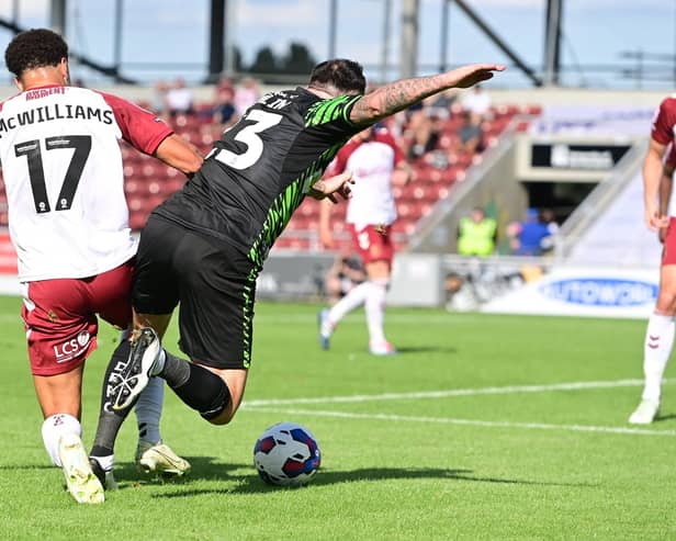 Doncaster's Lee Tomlin is brought down by Northampton's Shaun McWilliams for a penalty.
