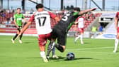 Doncaster's Lee Tomlin is brought down by Northampton's Shaun McWilliams for a penalty.