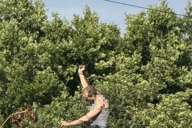 The man has been arrested after climing onto a house roof and throwing tiles.