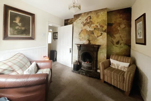 The second reception room also features a warming log burner.