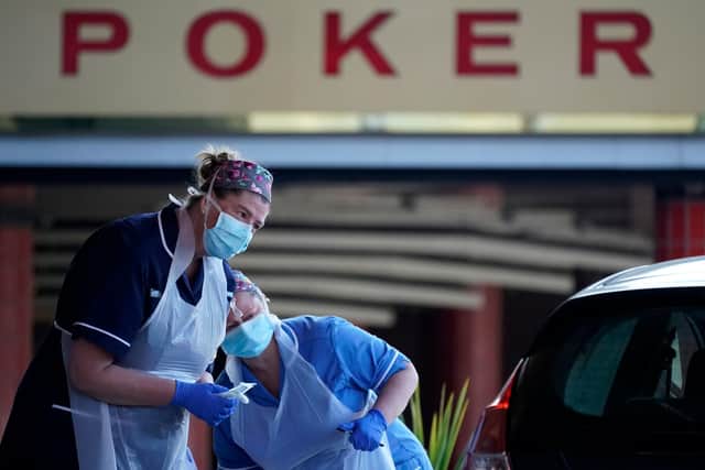 Nurses instruct and help National Health Service (NHS) workers as they self swab for Coronavirus (Covid-19) (Photo by Christopher Furlong/Getty Images)