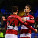 Harrison Biggins celebrates his goal with Zain Westbooke.