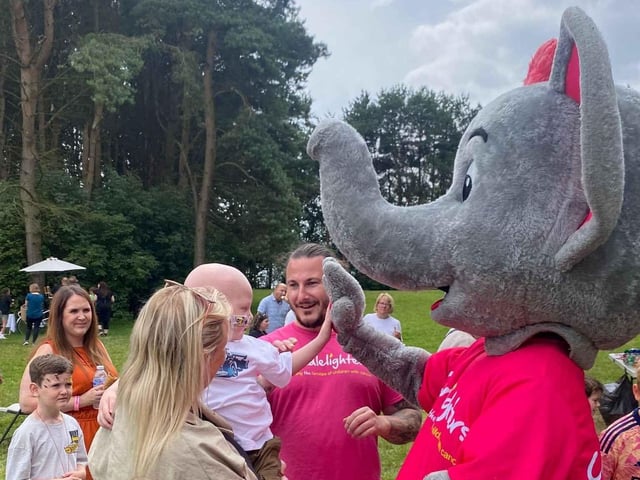 Families of children with cancer meeting Champ, the Candlelighters mascot, at the Bramhope Family Fun Day.