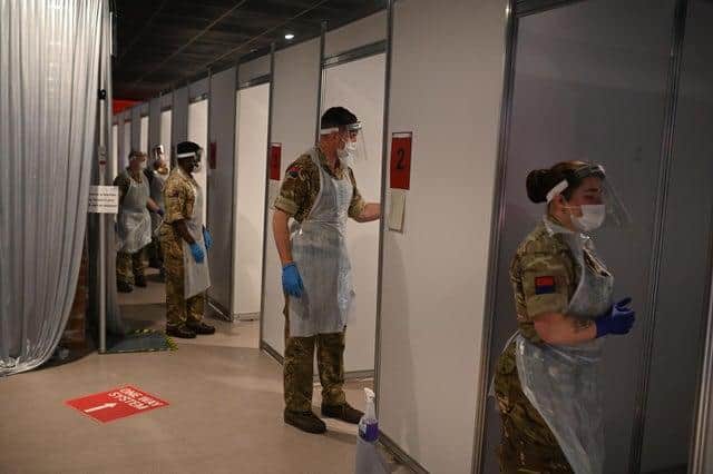 British Army soldiers, 19th Regiment Royal Artillery 5 Battery, staff testing booths inside Anfield Stadium in Liverpool (Photo by OLI SCARFF/AFP via Getty Images)