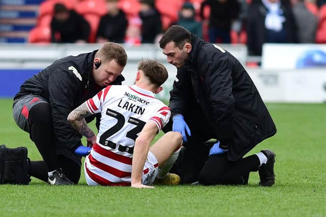 Doncaster's Charlie Lakin receives treatment before coming off against AFC Wimbledon.