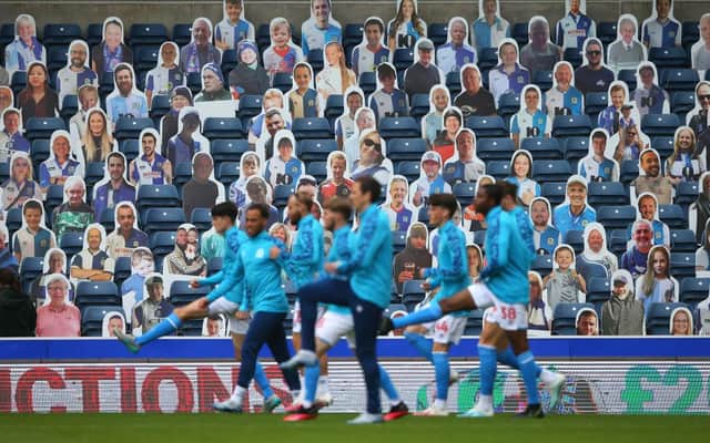 Blackburn Rovers players warm-up in front of cardboard cut outs at Ewood Park