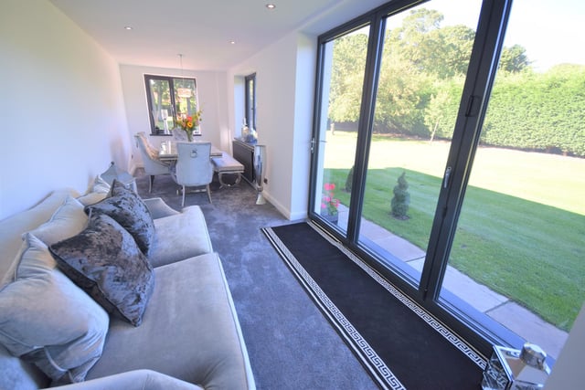 This lounge enjoys views to the garden, as well as double glazed windows, socket points, high ceilings and a high standard of presentation.