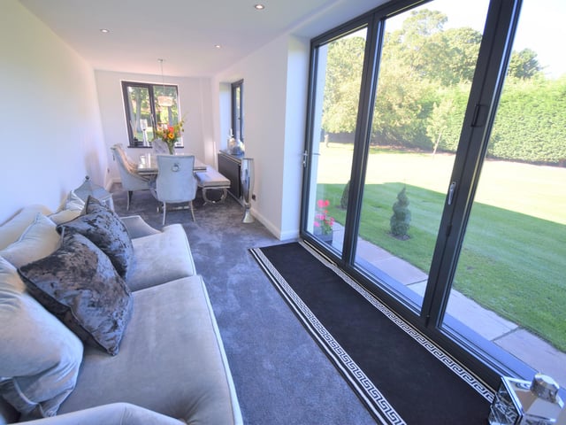 This lounge enjoys views to the garden, as well as double glazed windows, socket points, high ceilings and a high standard of presentation.
