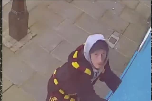 The moment a brazen thief dressed in a Harry Potter dressing gown was filmed swiping a CCTV camera.