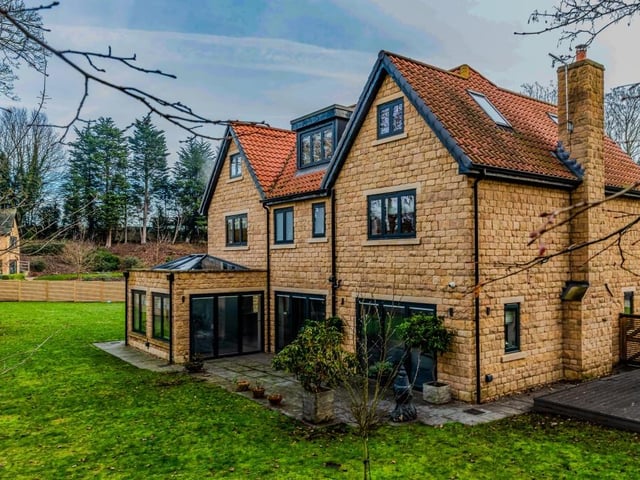 The village property has lawned gardens which circumnavigate the house.