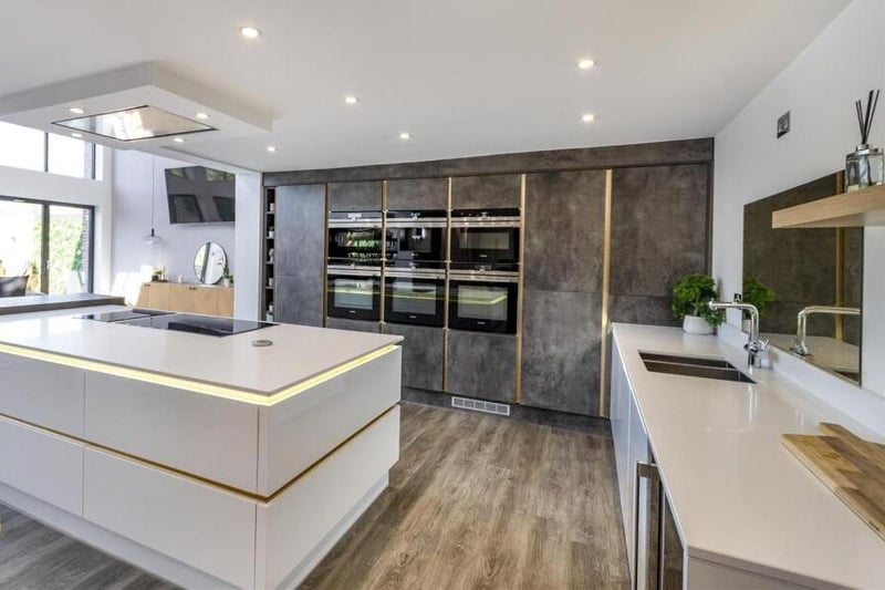 A high spec kitchen with island and breakfast bar.