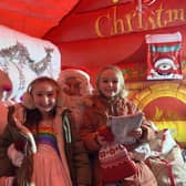 Lucy Lidster (aged 7) and Poppy Lidster (aged 6) delighted to meet Santa for a photo.