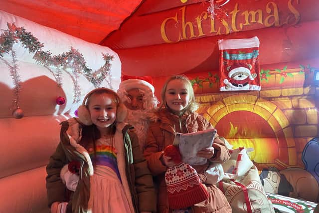 Lucy Lidster (aged 7) and Poppy Lidster (aged 6) delighted to meet Santa for a photo.
