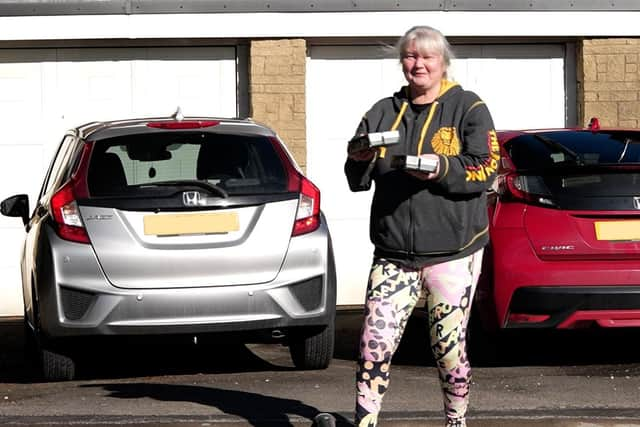 Heather White from Blackburn accepts delivery by drone (photo: Ben Frith)