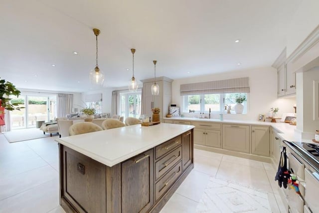 Looking from the kitchen with its central island to the open plan dining and lounge areas.