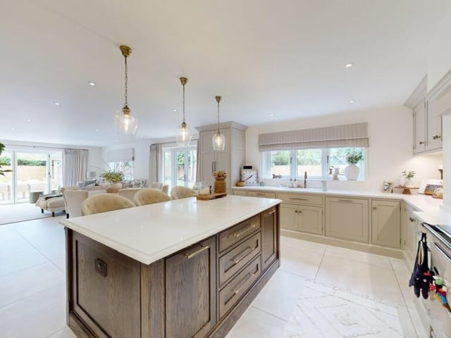 Looking from the kitchen with its central island to the open plan dining and lounge areas.