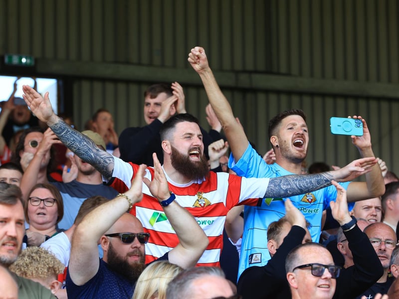 Doncaster Rovers fans celebrate as the full-time whistle blows