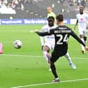 Doncaster Rovers midfielder Zain Westbrooke puts the ball in the box against MK Dons.