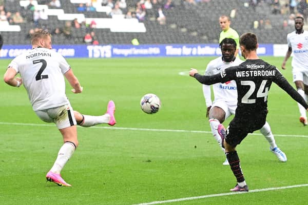 Doncaster Rovers midfielder Zain Westbrooke puts the ball in the box against MK Dons.