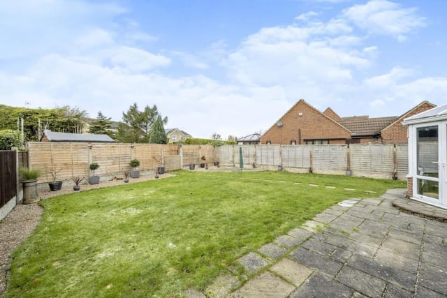 To the rear of the property is a good sized lawned garden with patio areas and pebbled borders.