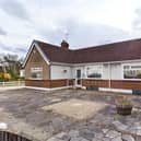 Paved front garden with boundary fence and driveway providin of road parking  and access to the garage