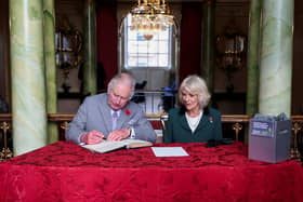 King Charles III and Camilla, Queen Consort, sign the visitor book as Donaster becomes a city