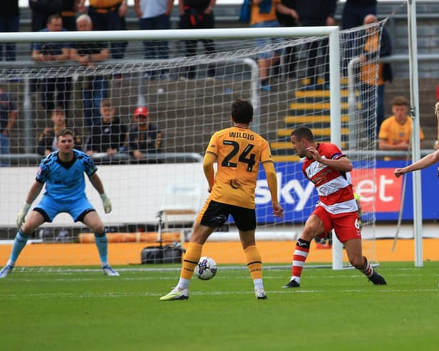 Newport County's Will Evans fires home his second goal against Doncaster Rovers to make it 4-0.