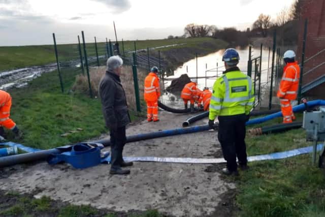 Environment Agency officers in action pumping water out of fields in Fishlake