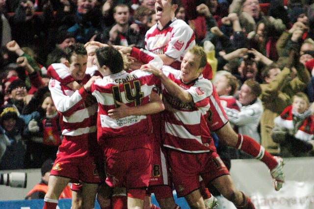Doncaster Rovers celebrate after Paul Green put them ahead in extra time against Arsenal.
