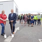 Kate Carville, Project Clinical Lead Nurse (left) and Richard Parker OBE, Chief Executive (right), with the project team in the background