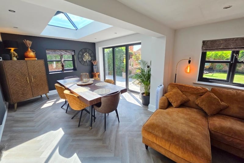 The spacious open plan arrangement on the ground floor includes the kitchen, with dining and family areas.