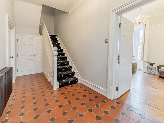 The hallway with staircase leading up.