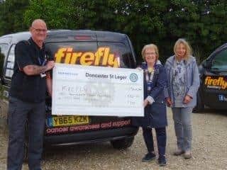 Fiona Gould and Christine Street presenting the money to Ian Bacchus from Firefly 