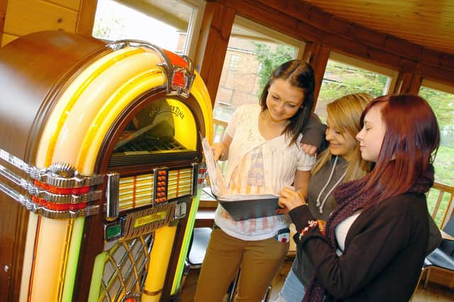 Natasha Frew, 16, Amber Borkowska, 15 and Lucy Tulley, 16, pictured by the juke box at Shakers youth cafe. Picture: Marie Caley D2282MC