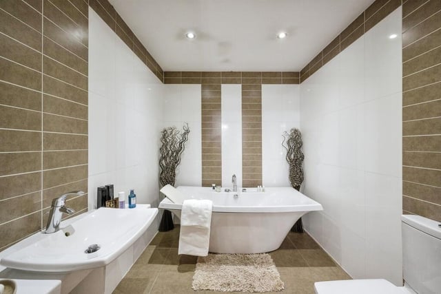 A stylish tiled bathroom.