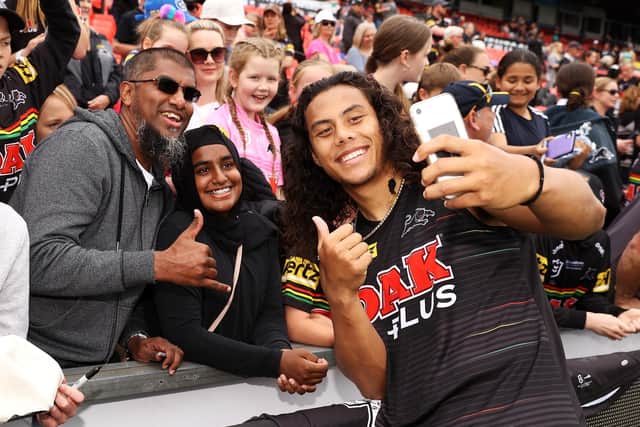 Jarome Luai poses for photographs with supporters after a Penrith Panthers NRL training session (photo by Mark Kolbe/Getty Images).