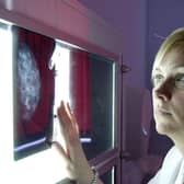Fire picture shows a radiographer checking a breast cancer scanner image